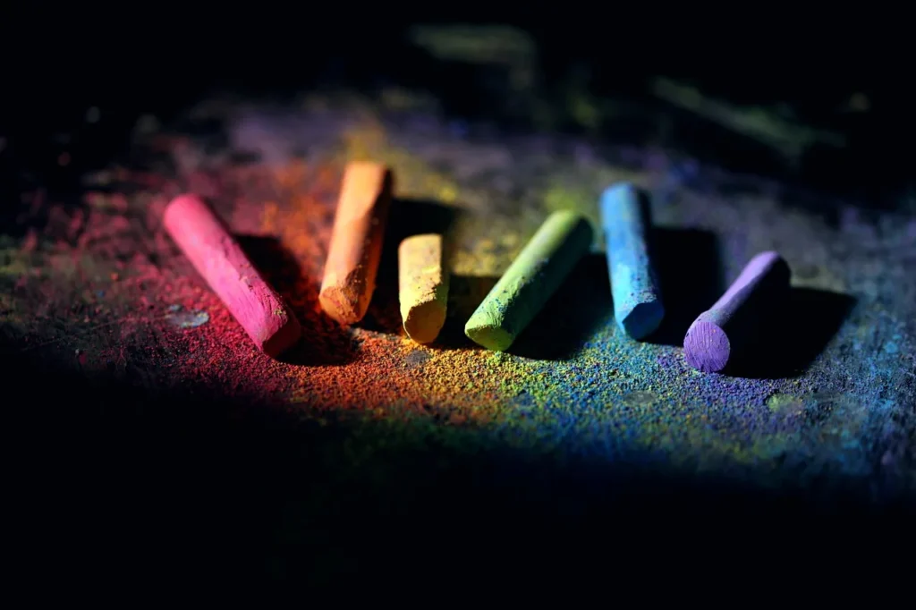 Colourful chalk sticks on a dark board