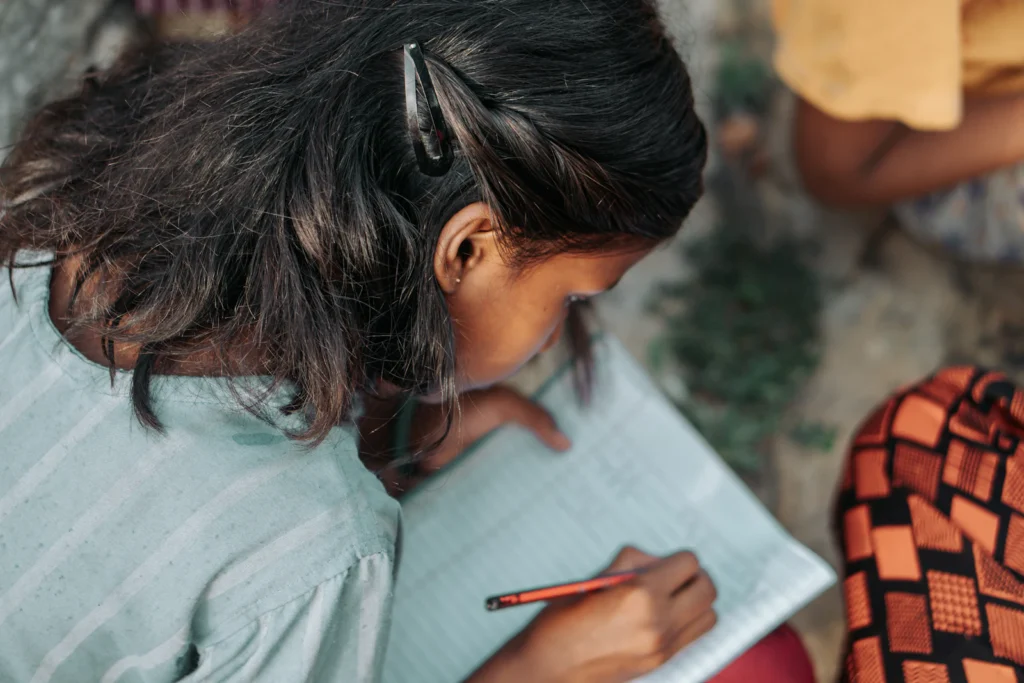 A girl writing her ideas in a notebook